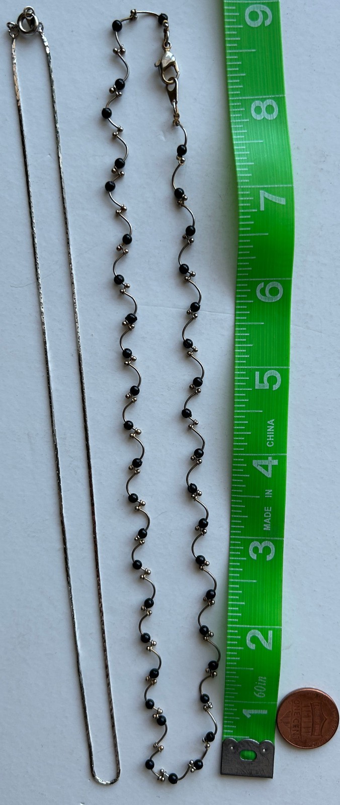 Lot of 2 Delicate Silvertone necklaces -One with black beads curvy design strand