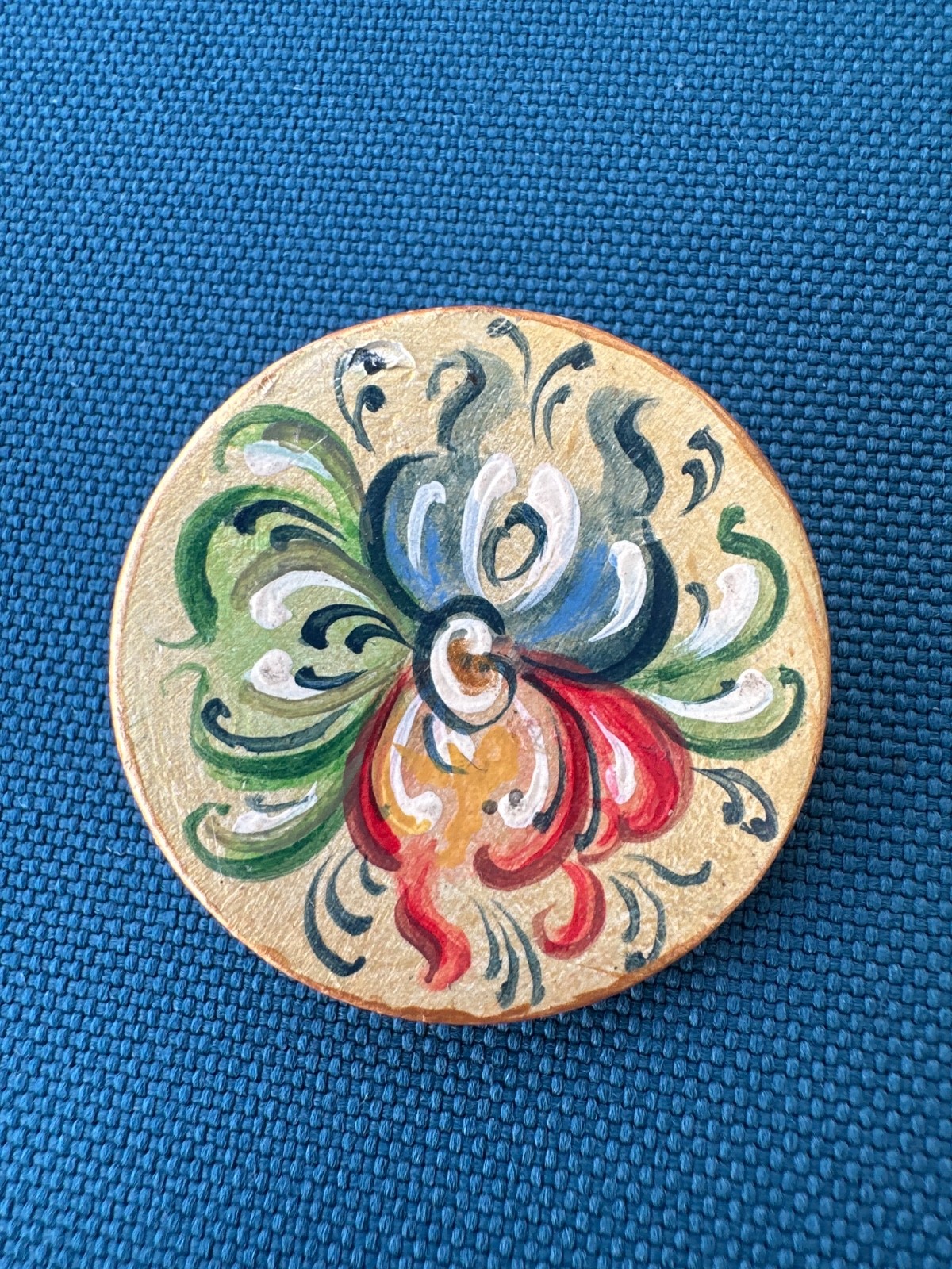 wooden brooch with traditional Norwegian rosemaling