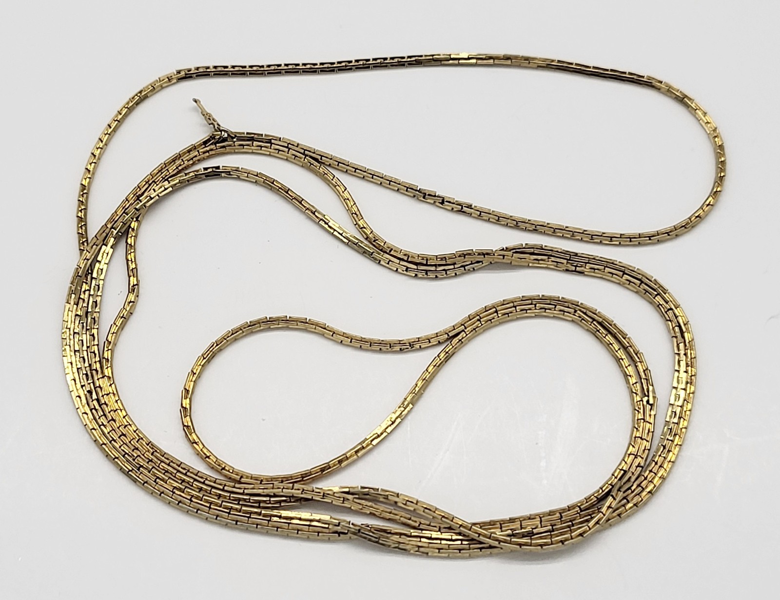 Vintage Trifari 54″ gold tone metal necklace, no clasp, Thin, sleek