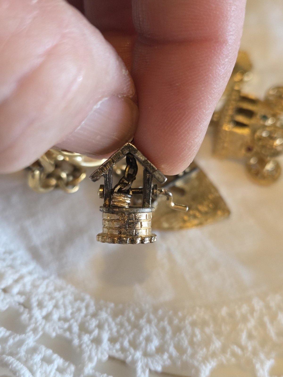 vintage Monet gold-tone charm bracelet features multiple detailed charms