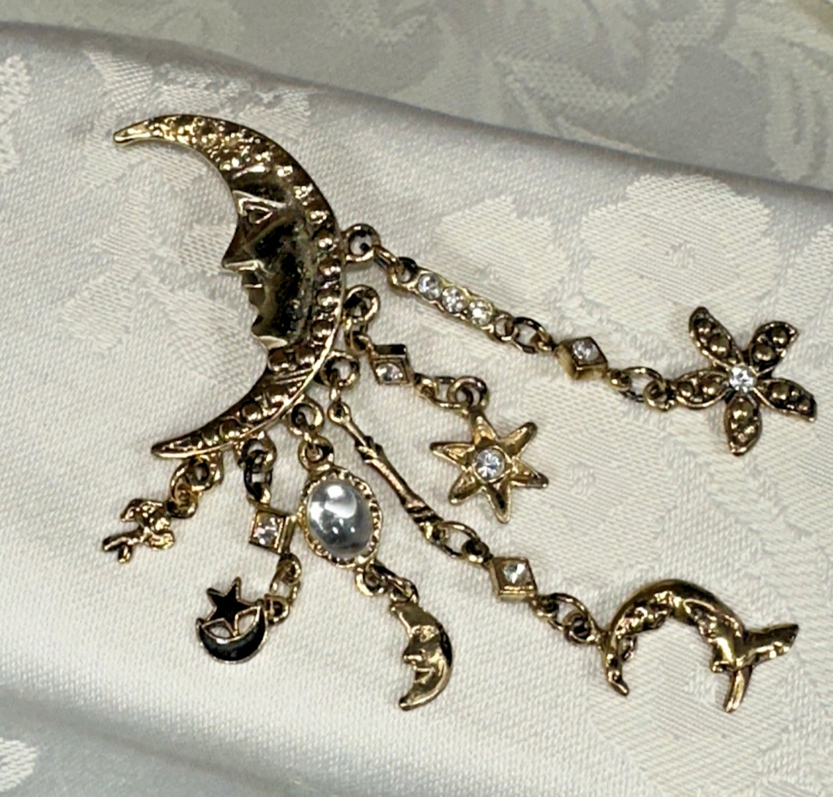 Gold Tone Crescent Moon With Dangling Stars, Cupid, Moon, Rhinestones Brooch