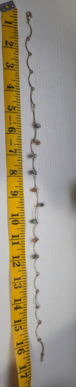 9 multicolor heart caged bead charms on a silvertone necklace