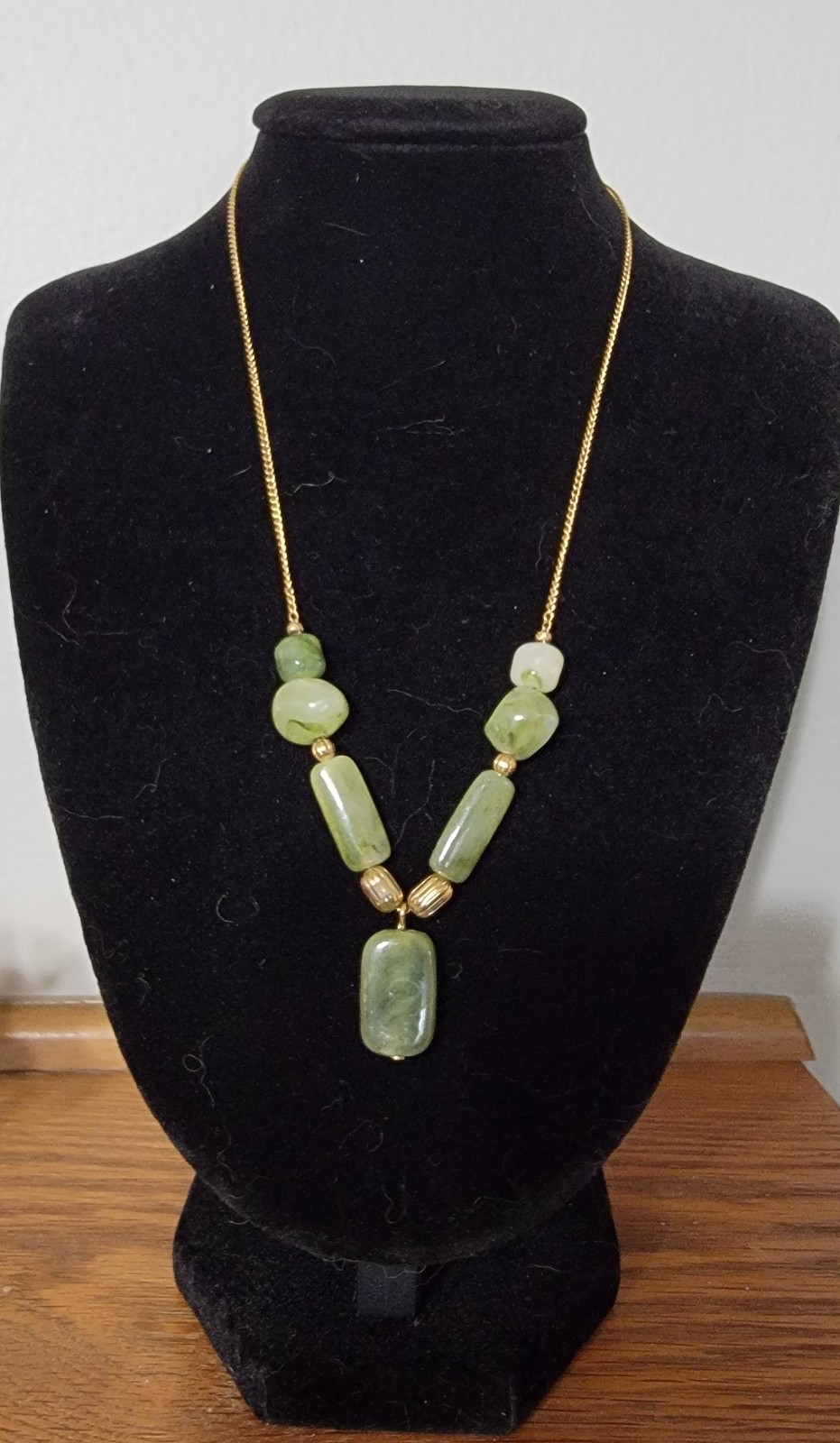 Vintage Act II necklace featuring polished green stones and a delicate gold-tone