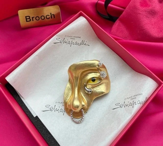 Schiaparelli yellow eye nose brooch with box