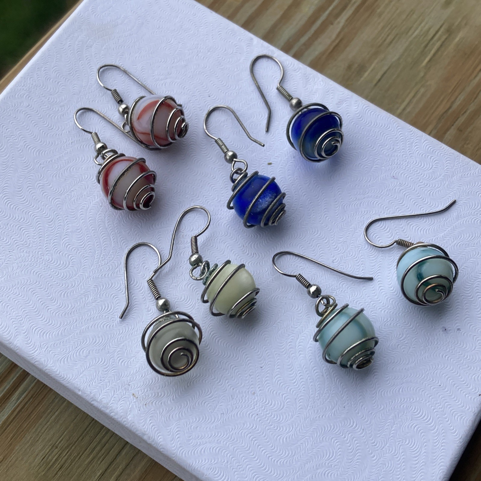 4 pr. vintage wire wrapped cased glass marble dangle, / pierced earrings