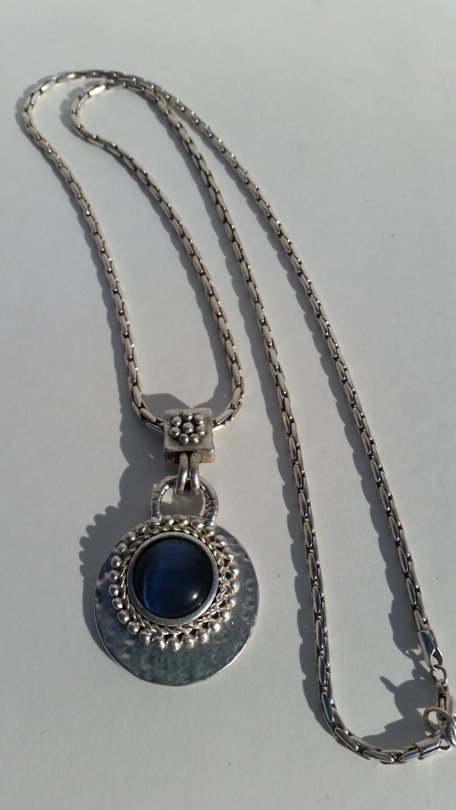 Blue Tiger Eye Cabochon style pendant with a convex formed silver toned reverse