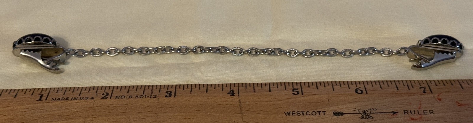 Vintage Silver Tone Cardigan Clip featuring two black oval stones