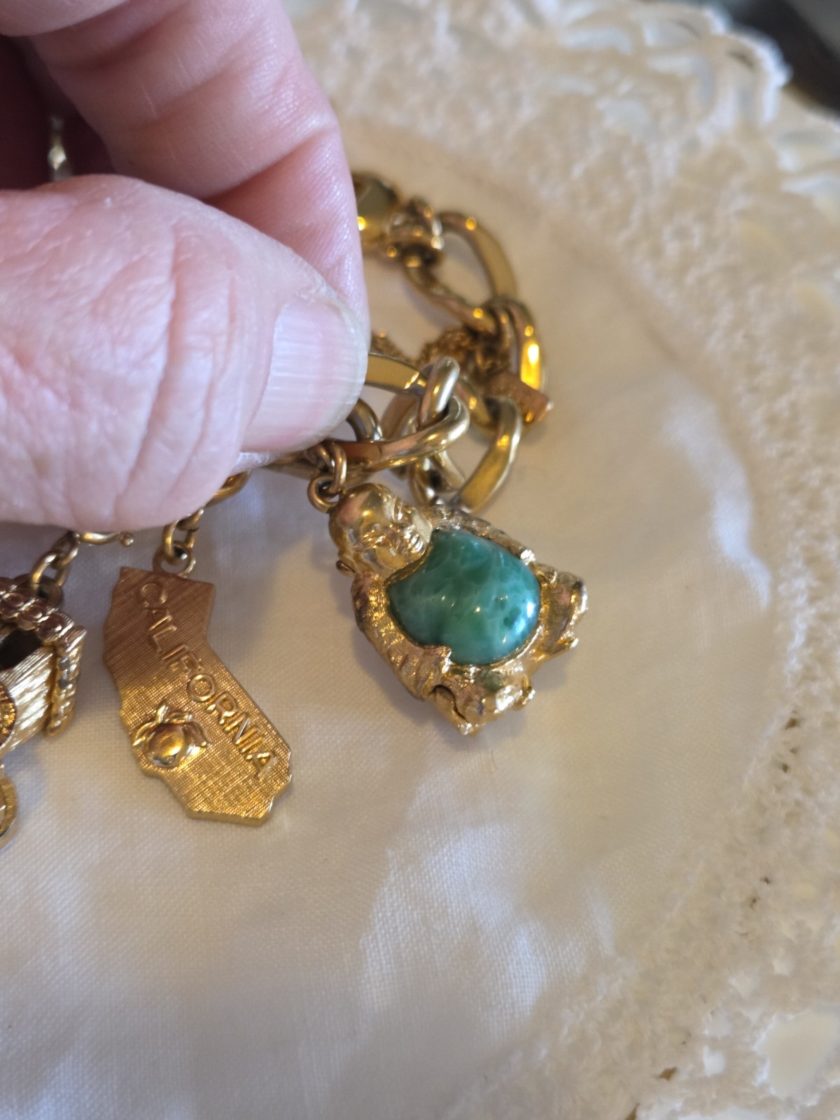 vintage Monet gold-tone charm bracelet features multiple detailed charms