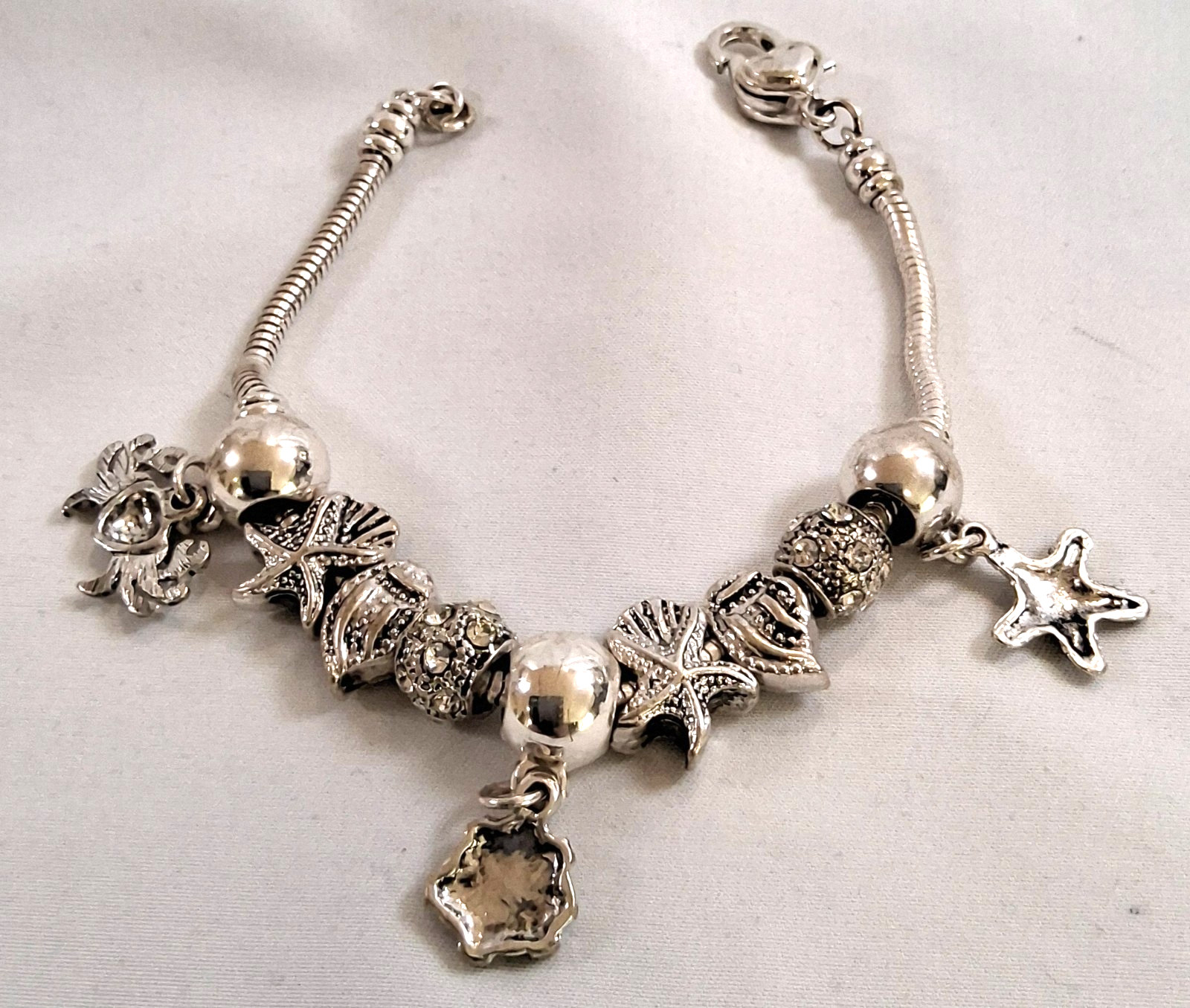 silver tone sea creatures shell 9 charm slide bracelet design