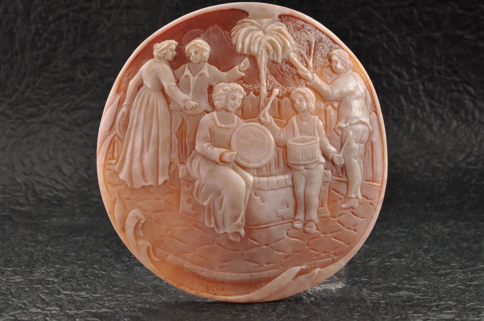 The Little Drummer: Round Shell Cameo of a Happy Family (99.0ct) sign by artist.