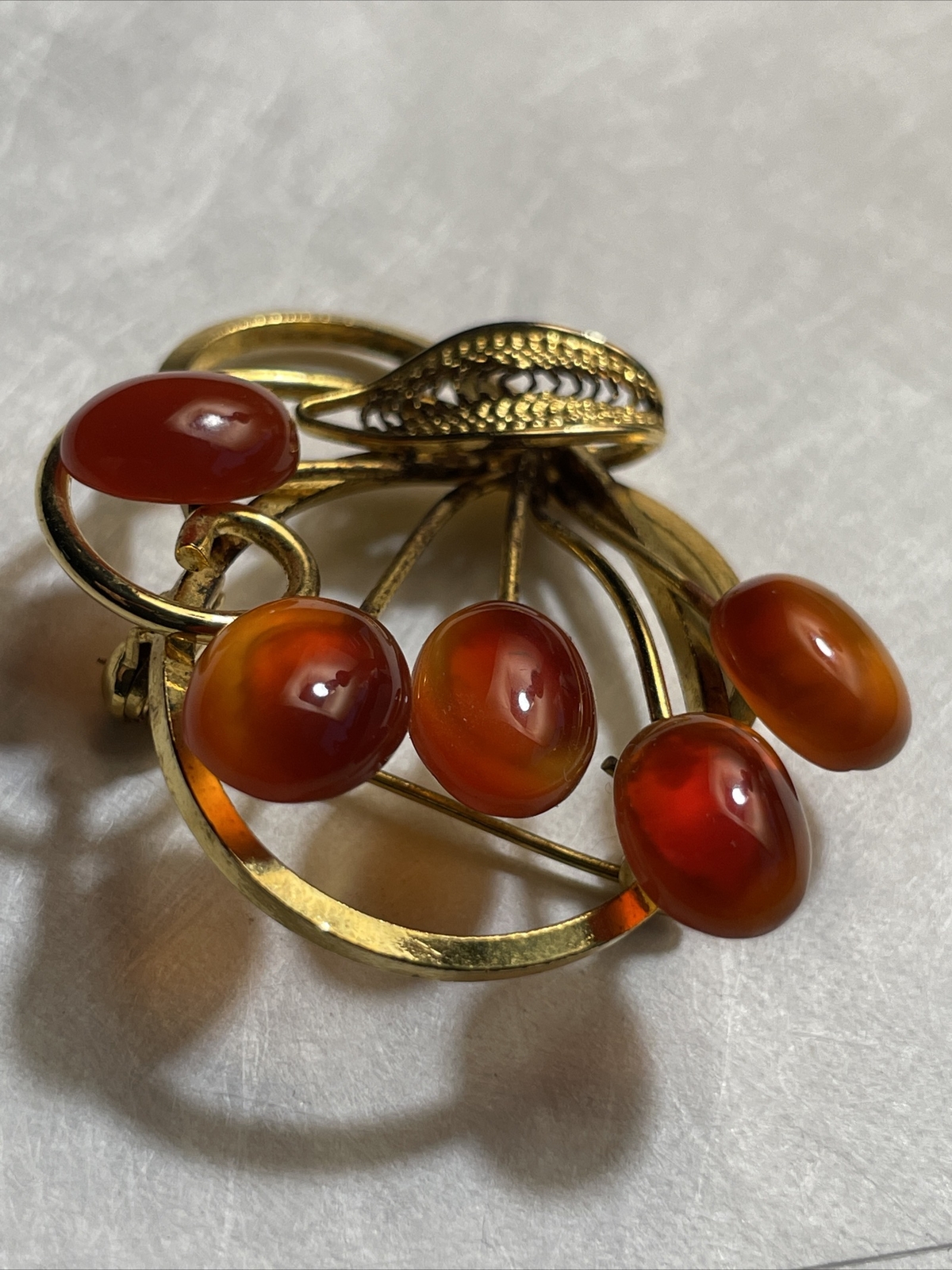 Vintage gold tone brooch with amber colored stones