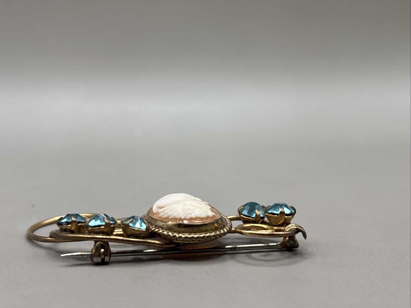 Unique 12k gold filled Cameo Broach Flanked W/Blue Rhinestones On Scroll Setting