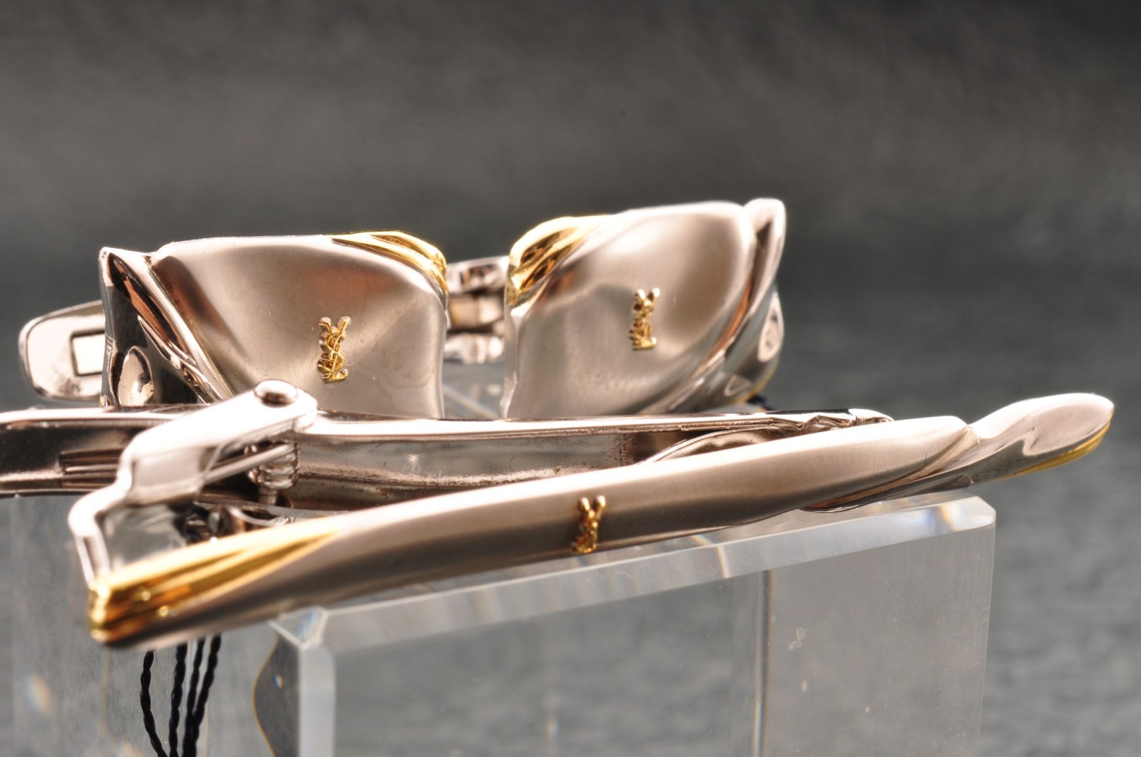 Near mint, gold and Cufflinks and silver tie clip, “Yves Saint Laurent”, case.
