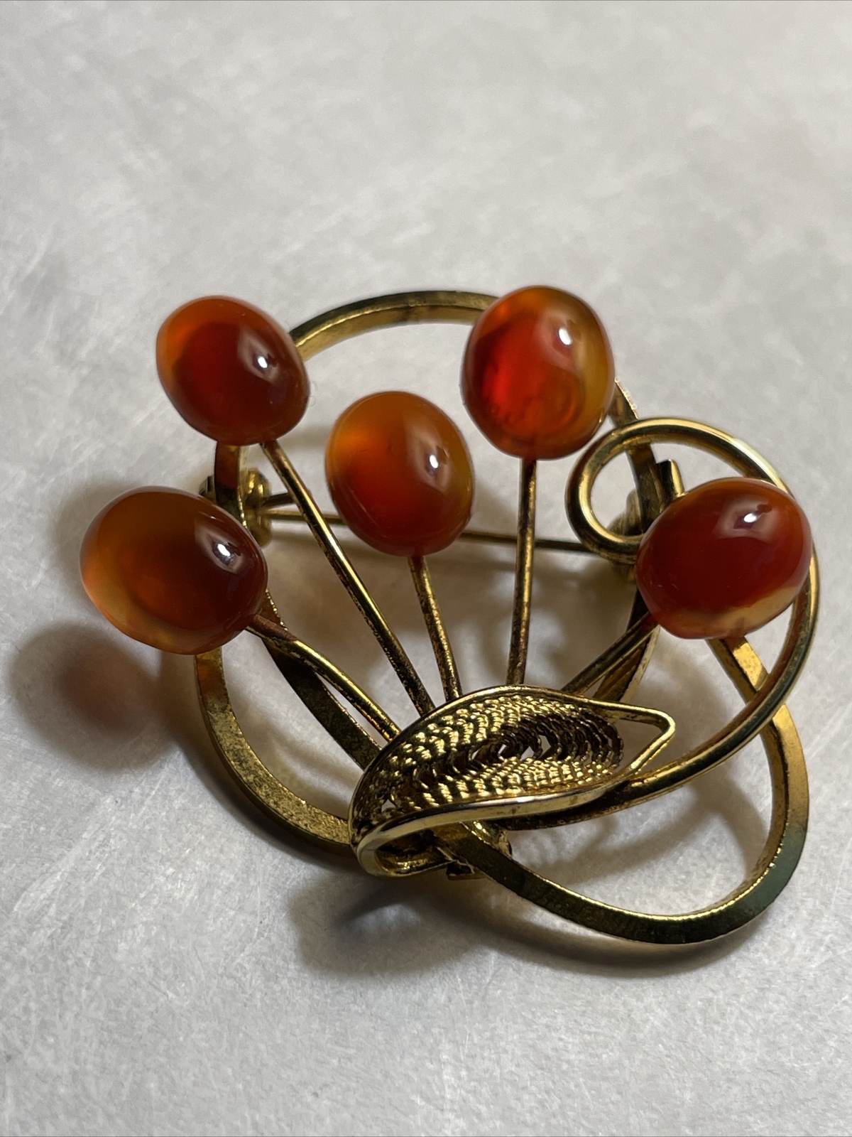 Vintage gold tone brooch with amber colored stones