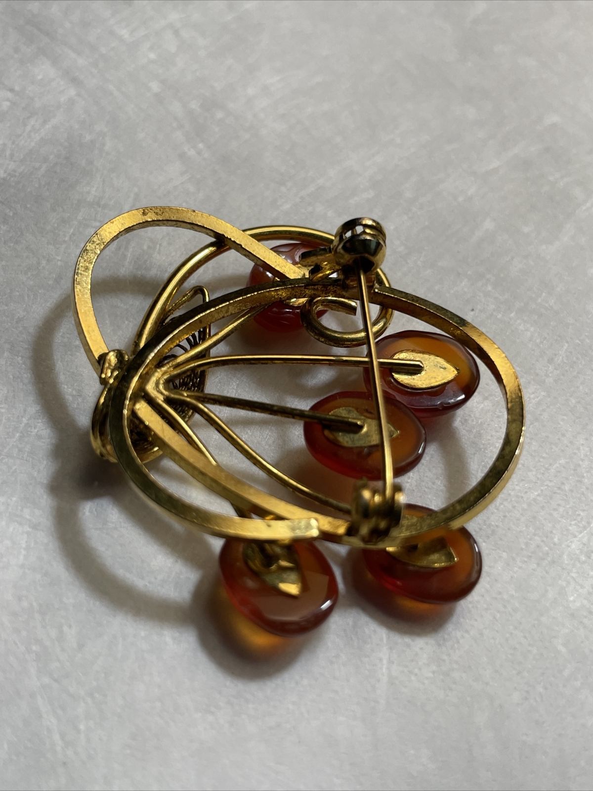 Vintage gold tone brooch with amber colored stones