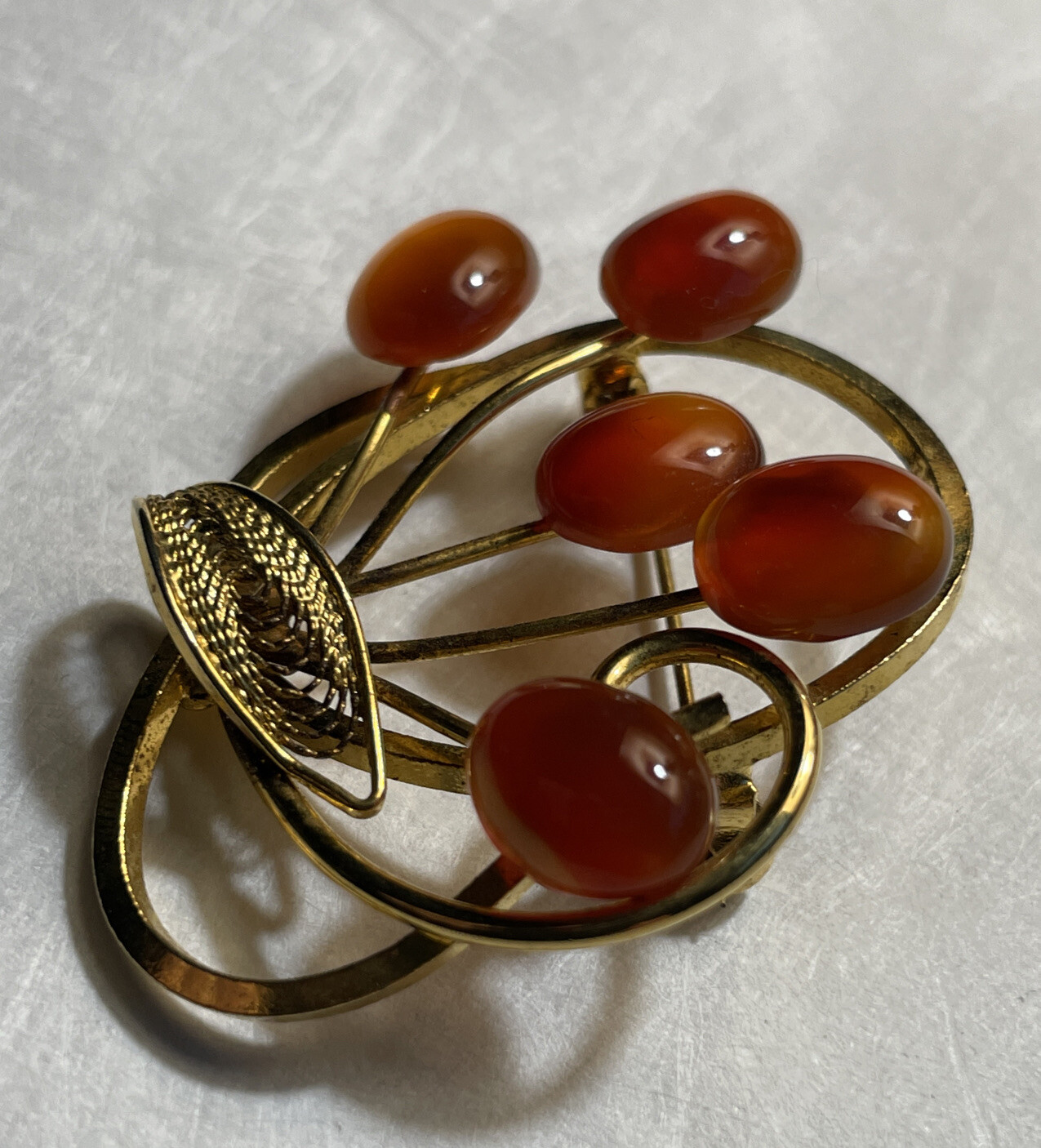 Vintage gold tone brooch with amber colored stones