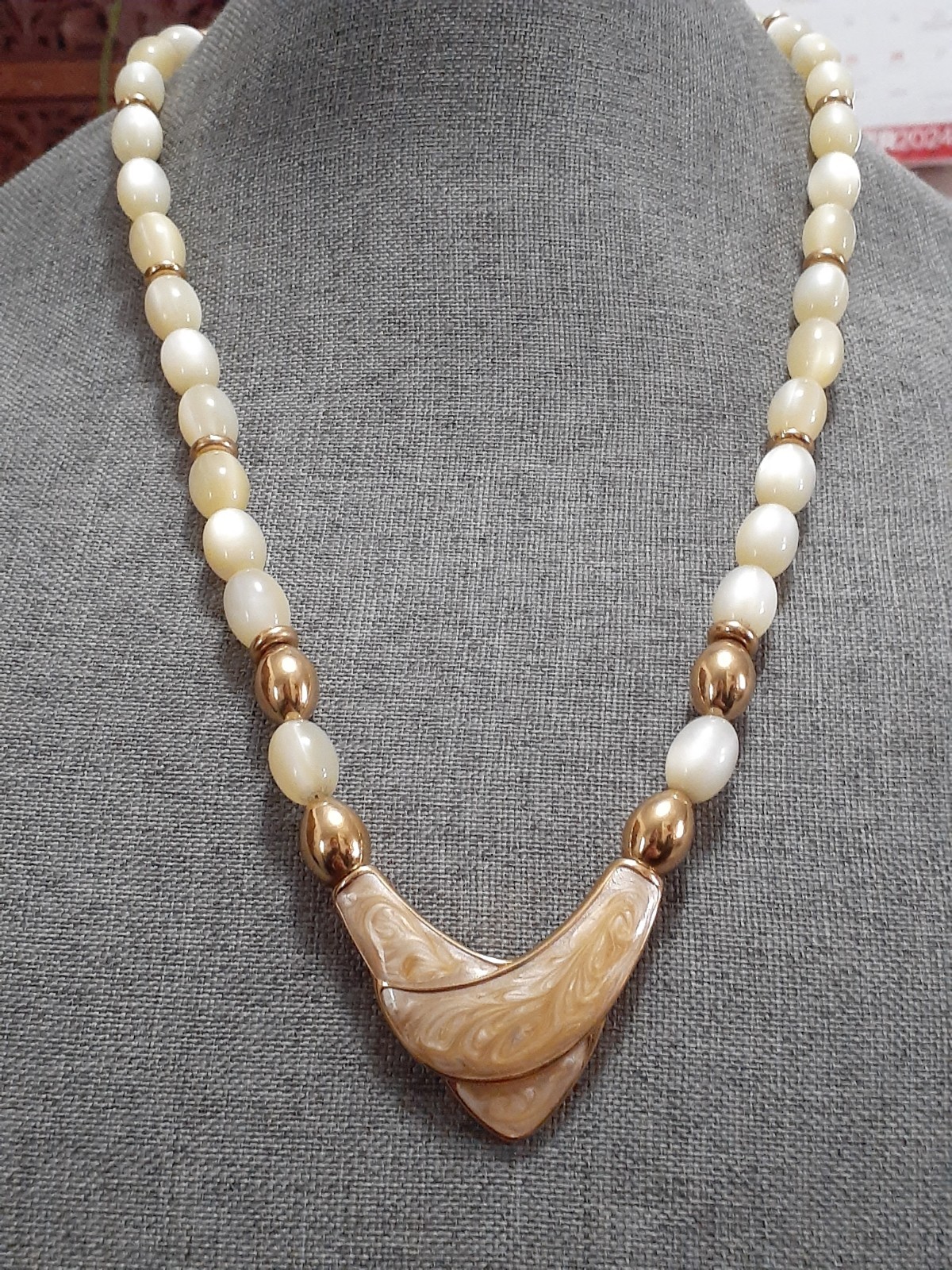 Napier champagne moonglow lucite bead necklace w/Chevron enamel pendant 24″