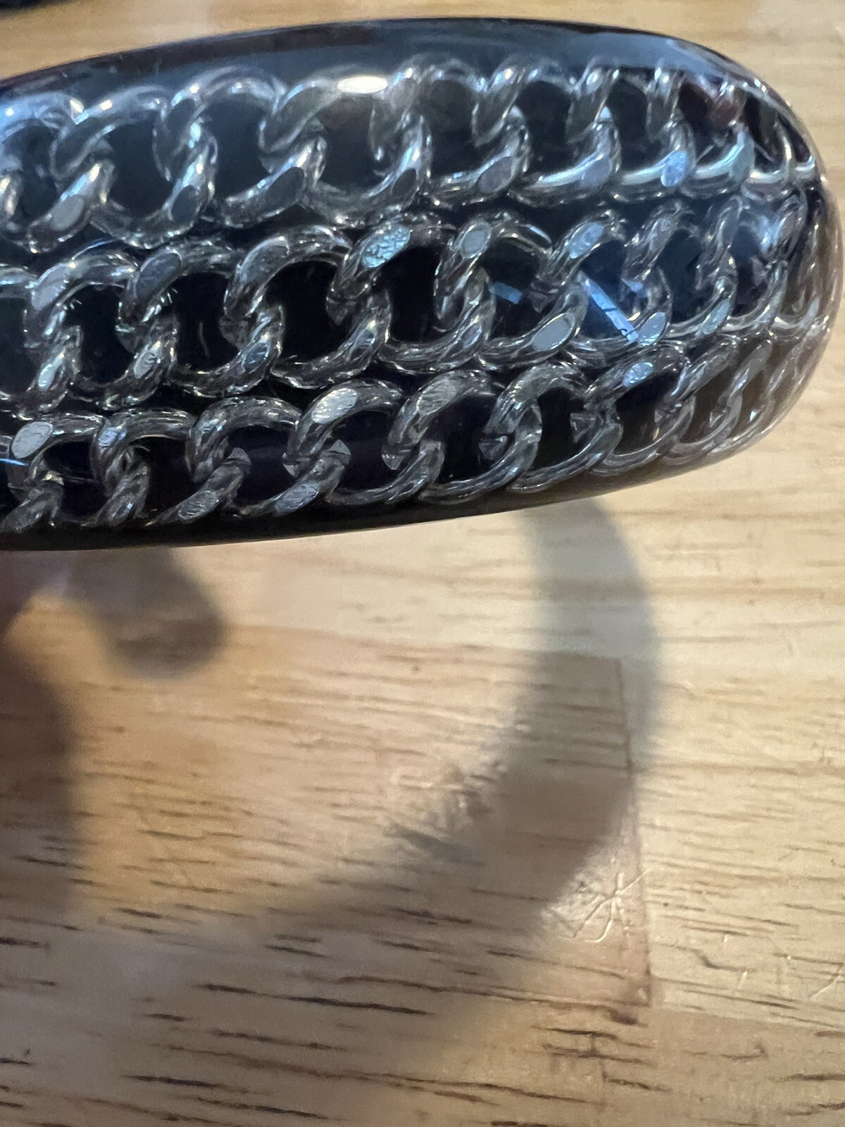 BLACK ACRYLIC LUCITE BANGLE WITH ENCASED SILVERTONE CHAINS