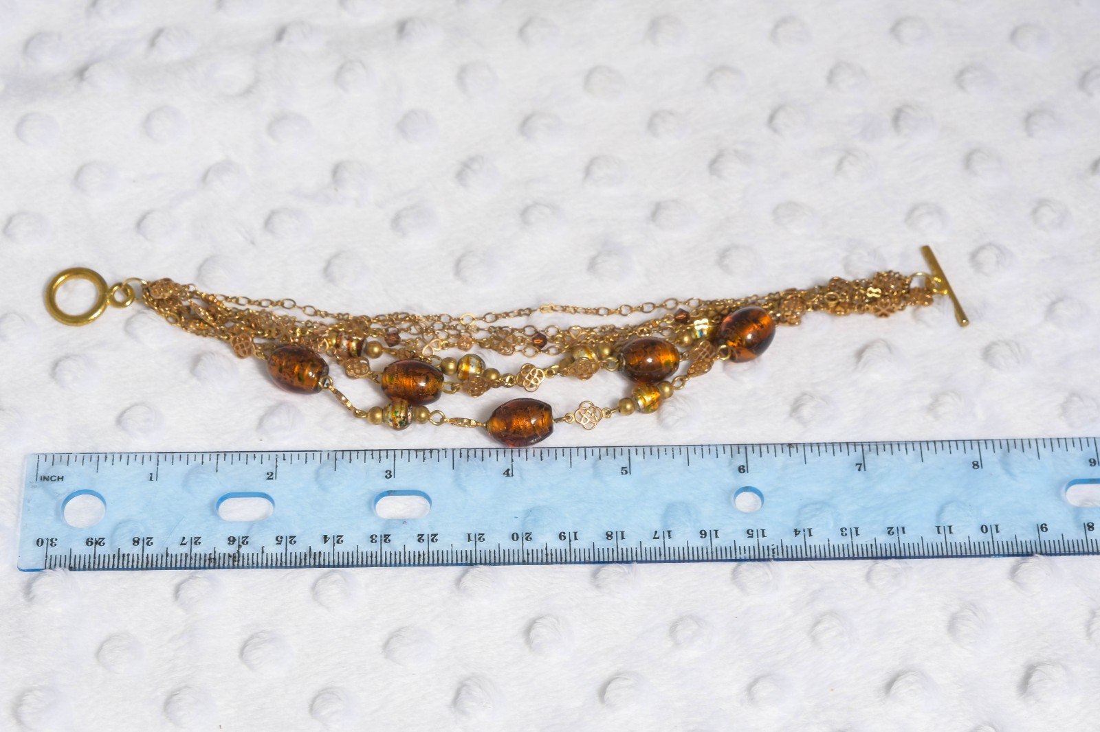 Vintage brass toned 7 strand toggle bracelet with Venetian foil type beading