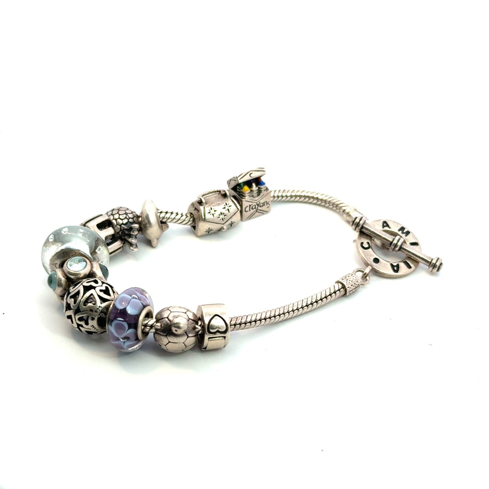 Authentic sterling silver chamilia 7.5in bracelet with 11 charms