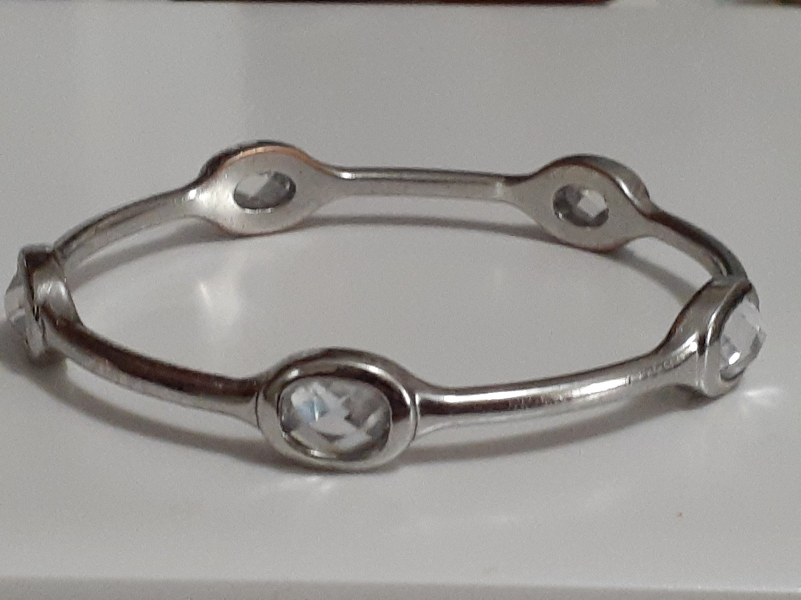 Fauceted crystal accent bangle bracelet Silvertone bezel set stones