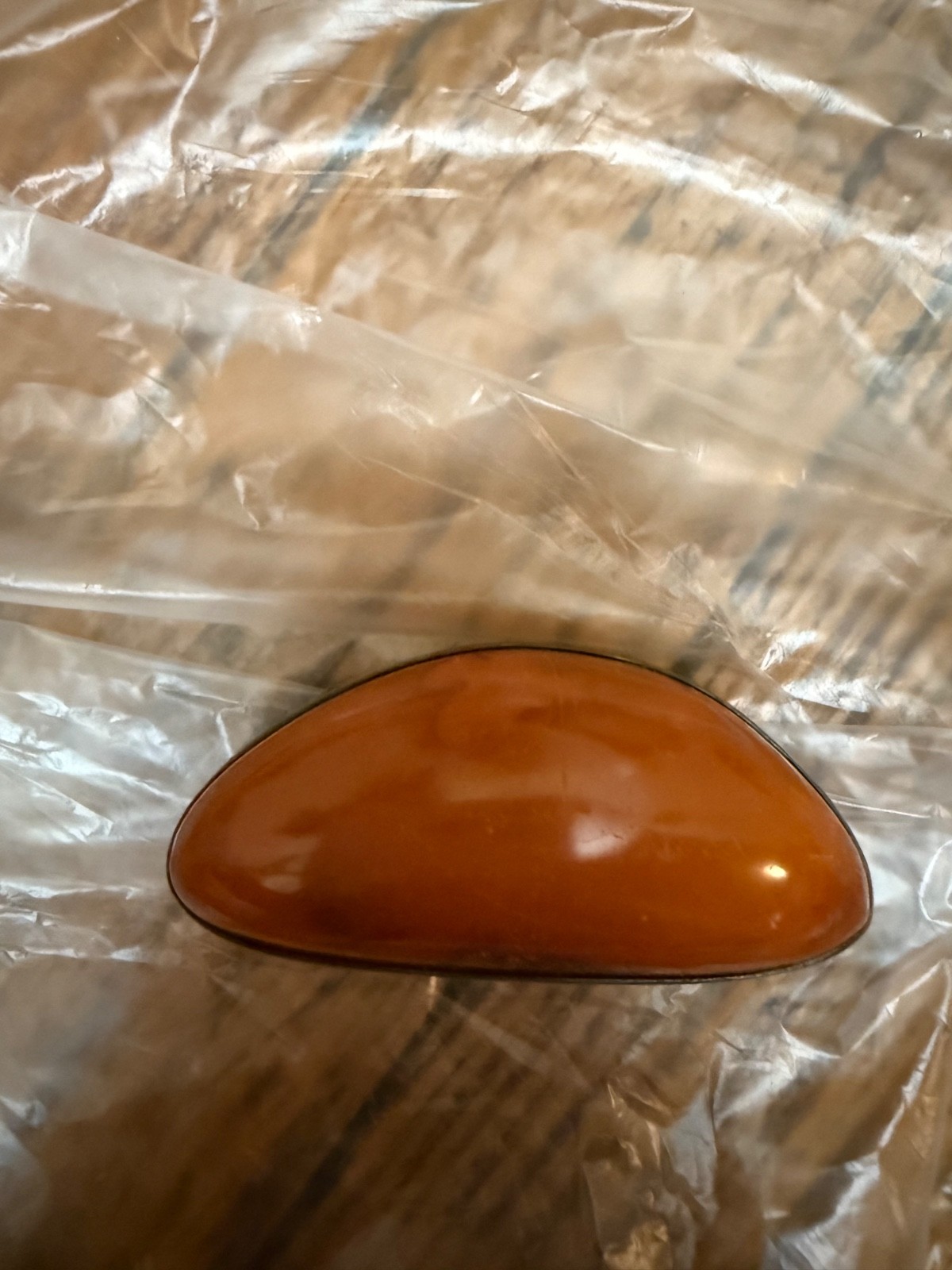 vintage sterling silver brooch features a large, warm-toned amber cabochon set