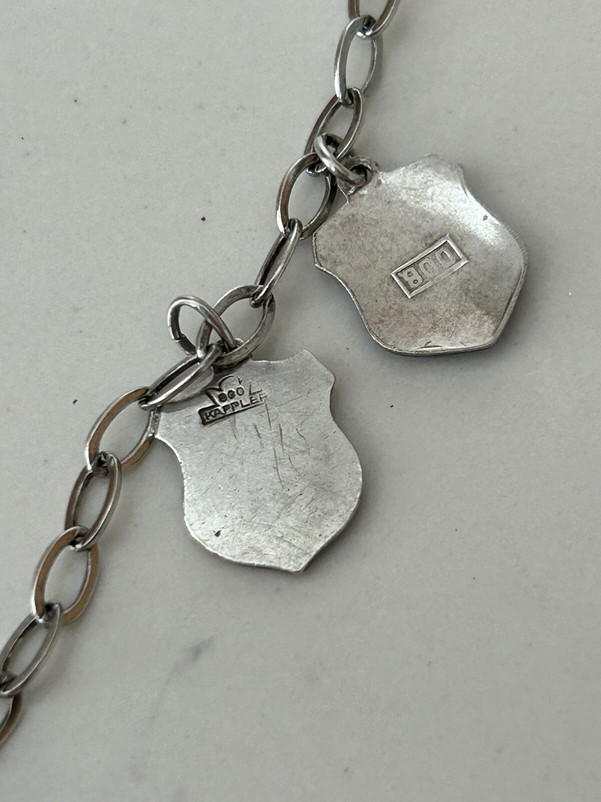 VINTAGE SOLID SILVER AND ENAMEL TRAVEL CHARM BRACELET6 COAT OF ARMS (8 TOTAL)