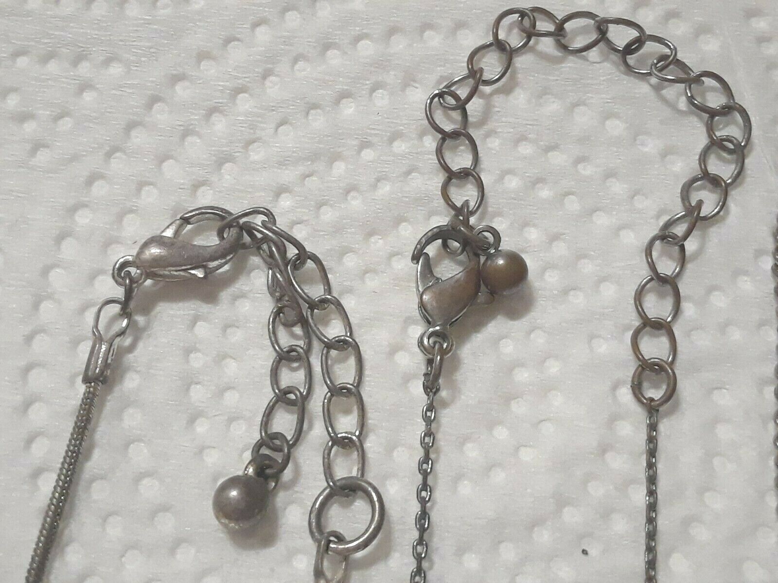 Lot of silver tone chain necklaces with rhinestone pendants. Coin, Love + Luck