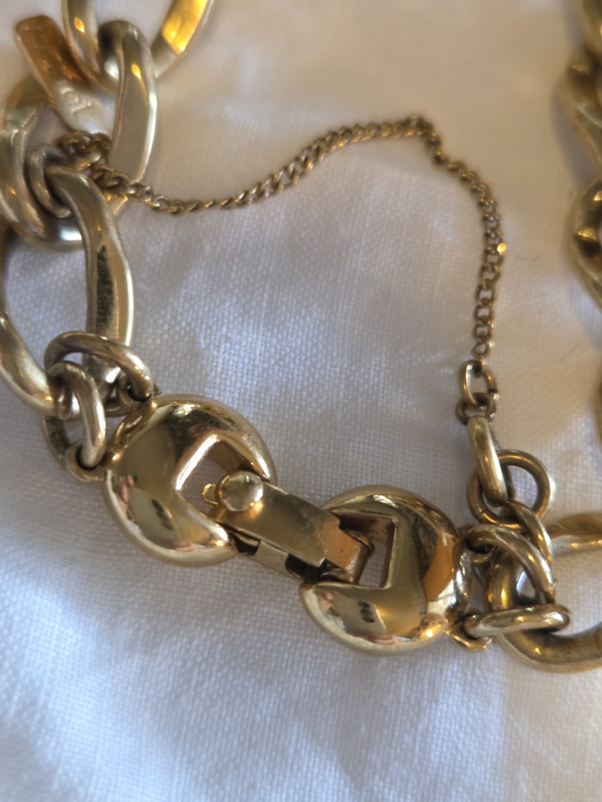 vintage Monet gold-tone charm bracelet features multiple detailed charms