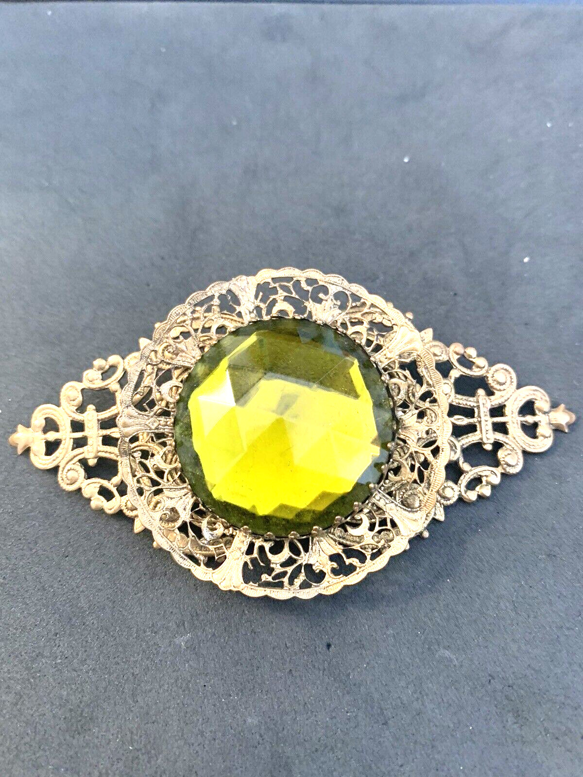 Vintage Bronze Color Filigree Brooch with a Large Green Stone