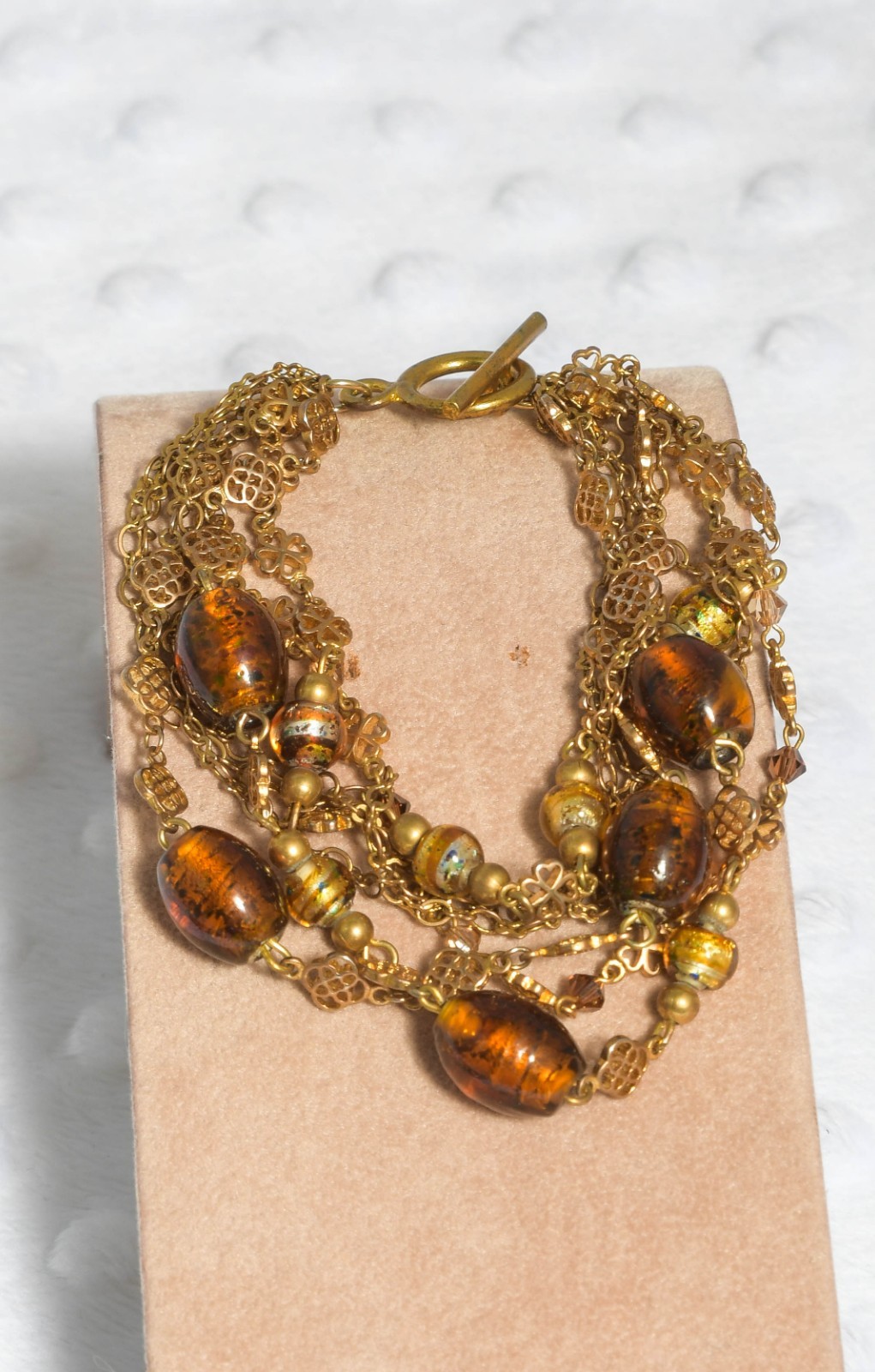Vintage brass toned 7 strand toggle bracelet with Venetian foil type beading