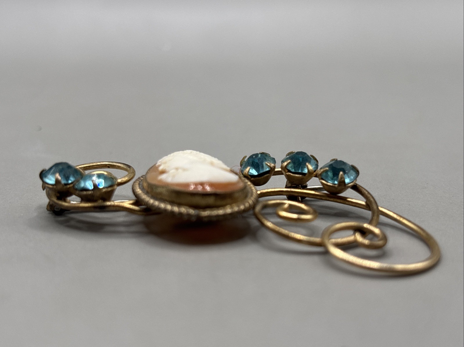 Unique 12k gold filled Cameo Broach Flanked W/Blue Rhinestones On Scroll Setting