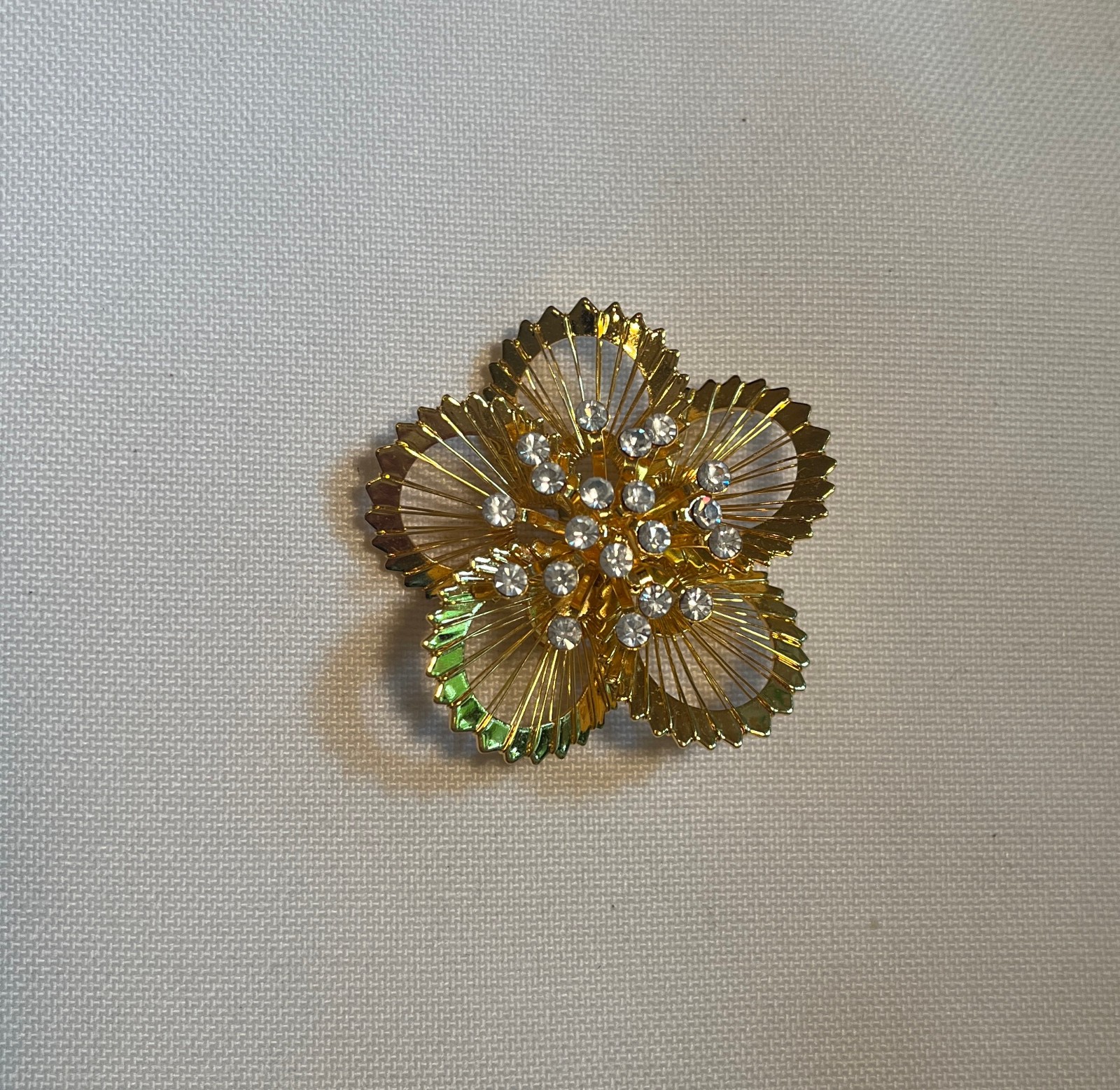 Gold tone Flashy Floral Pin With Multiple Simulated Diamonds