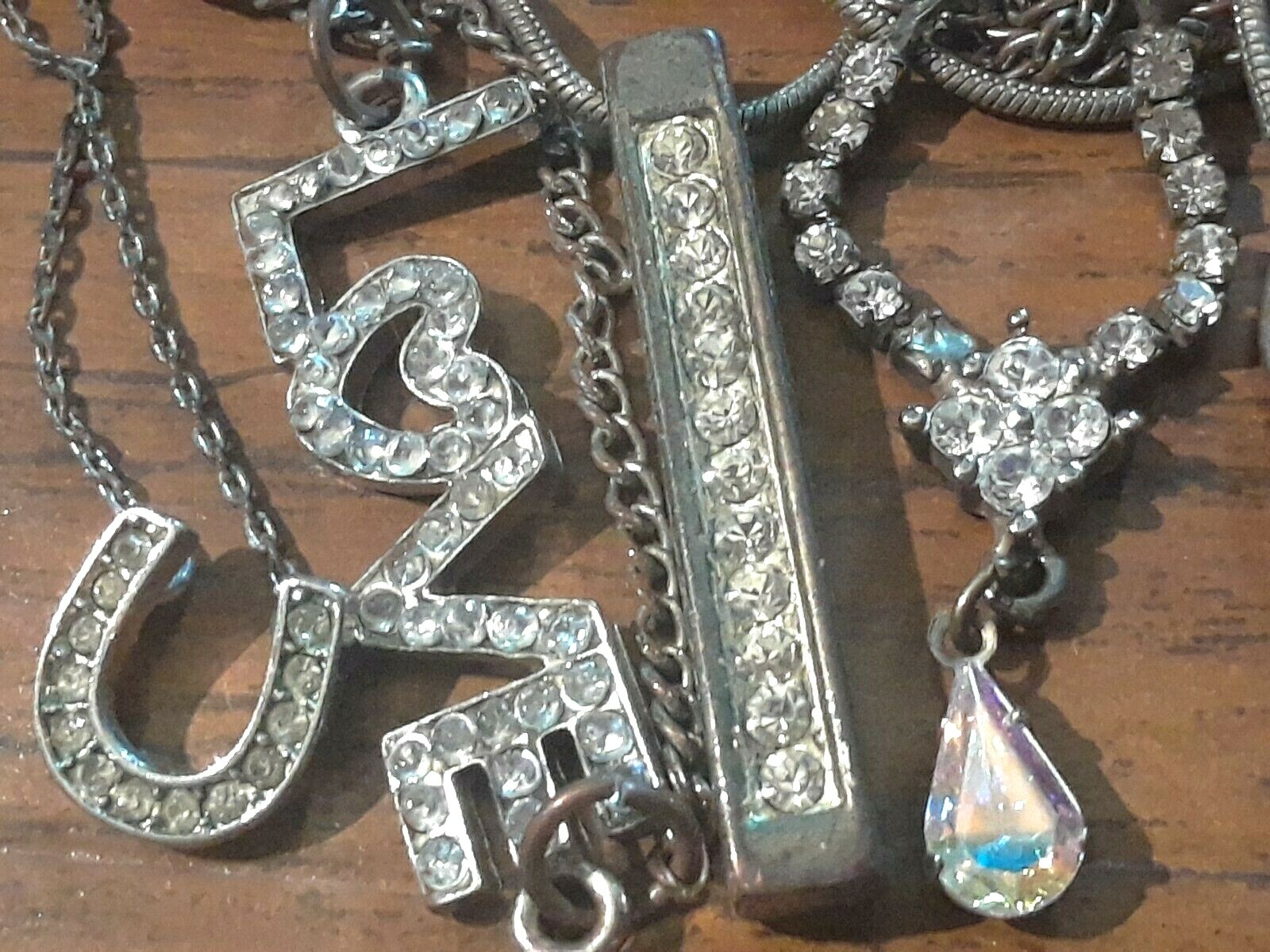 Lot of silver tone chain necklaces with rhinestone pendants. Coin, Love + Luck