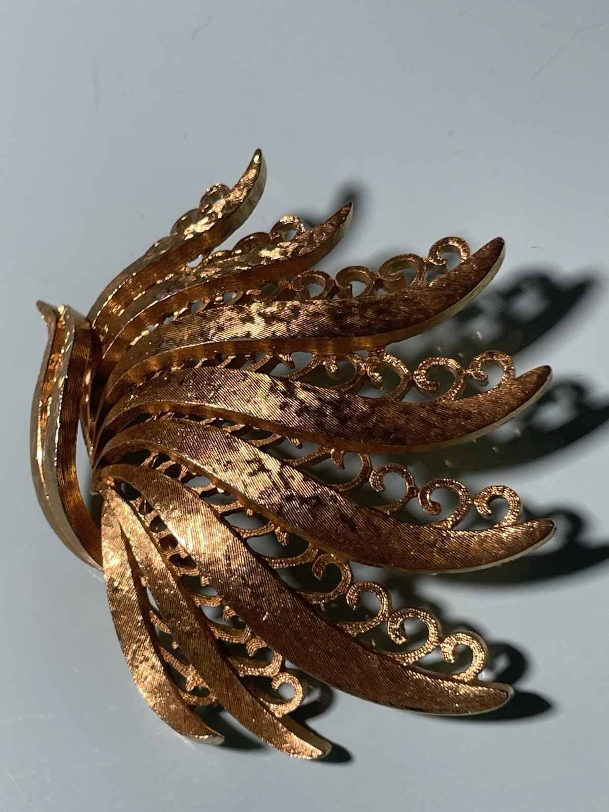 Vintage Monet Gold Tone Textured Peacock Filigree Brooch