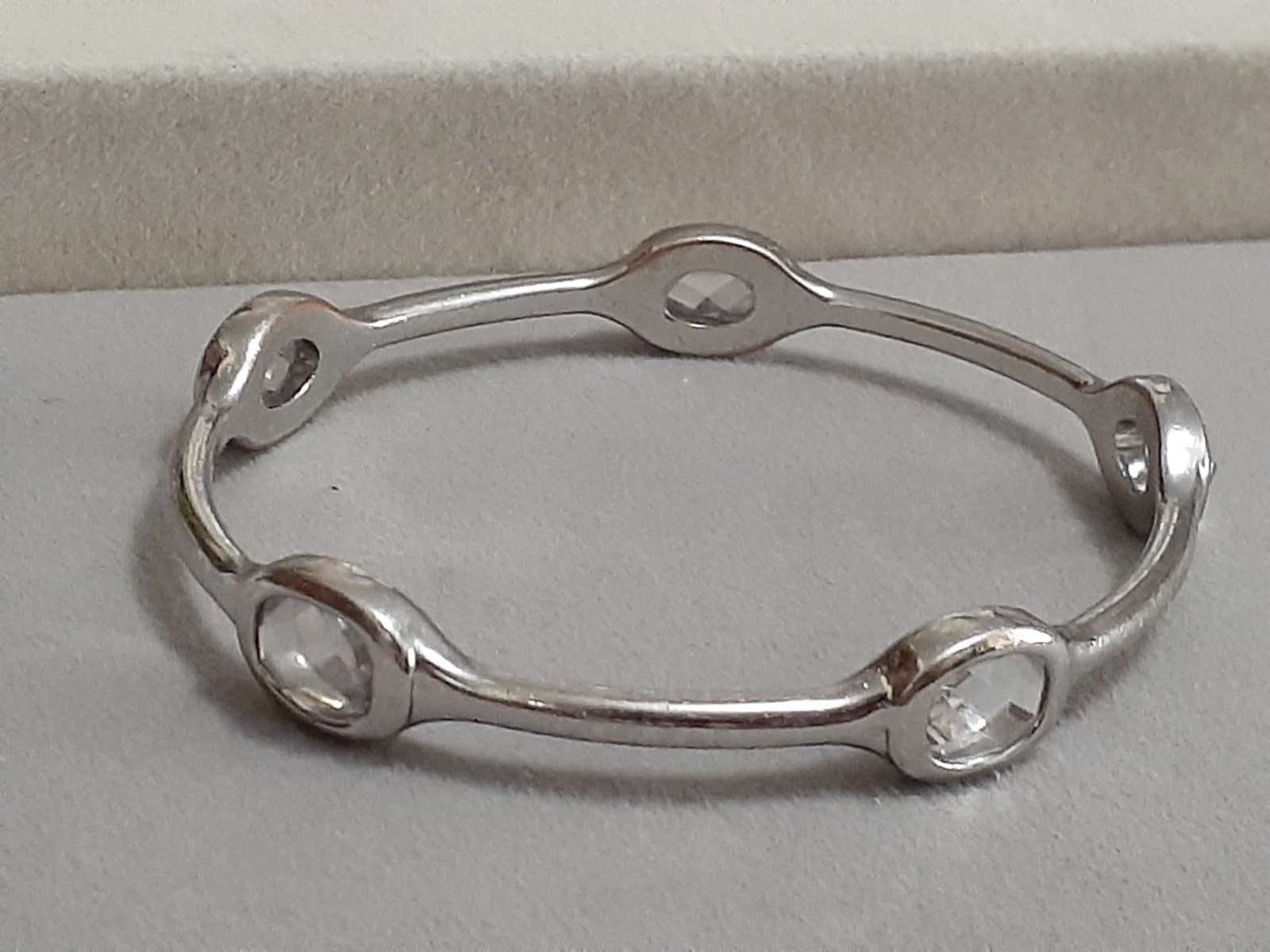 Fauceted crystal accent bangle bracelet Silvertone bezel set stones