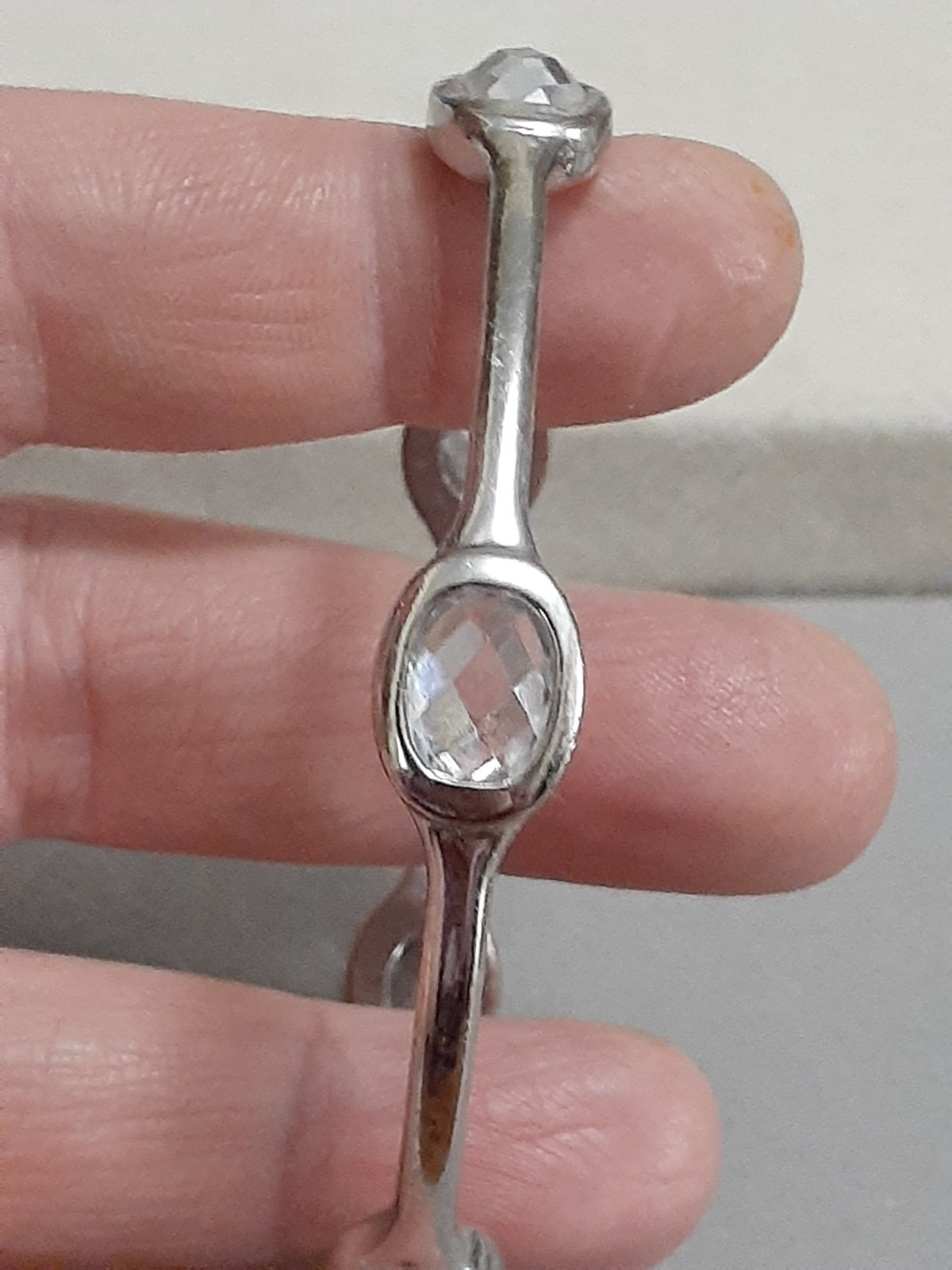 Fauceted crystal accent bangle bracelet Silvertone bezel set stones