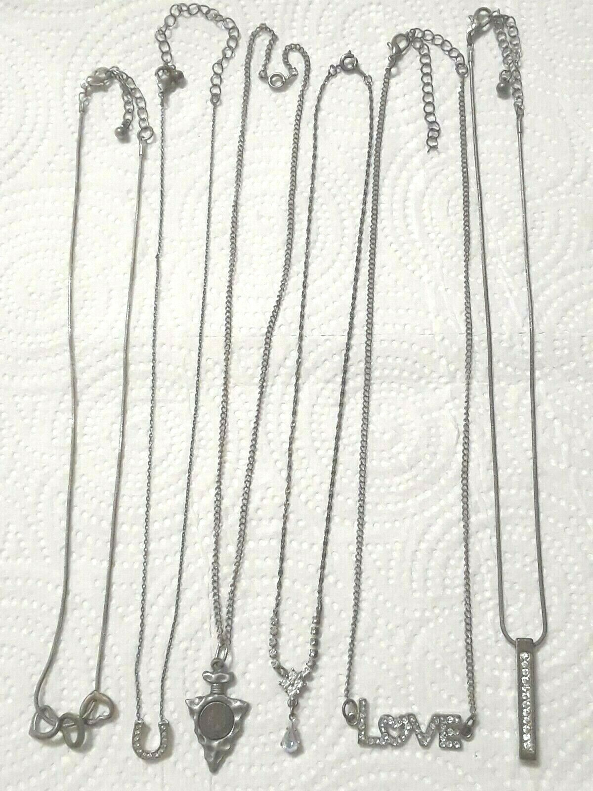 Lot of silver tone chain necklaces with rhinestone pendants. Coin, Love + Luck