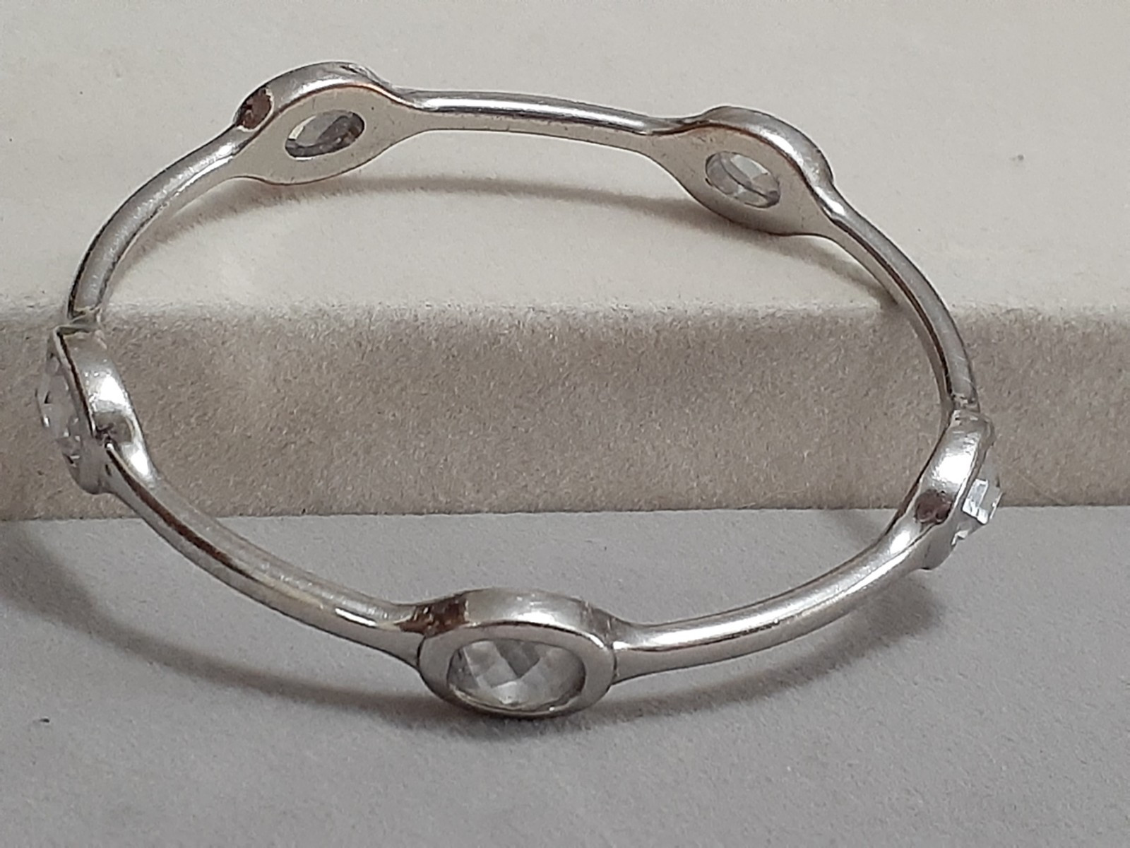 Fauceted crystal accent bangle bracelet Silvertone bezel set stones