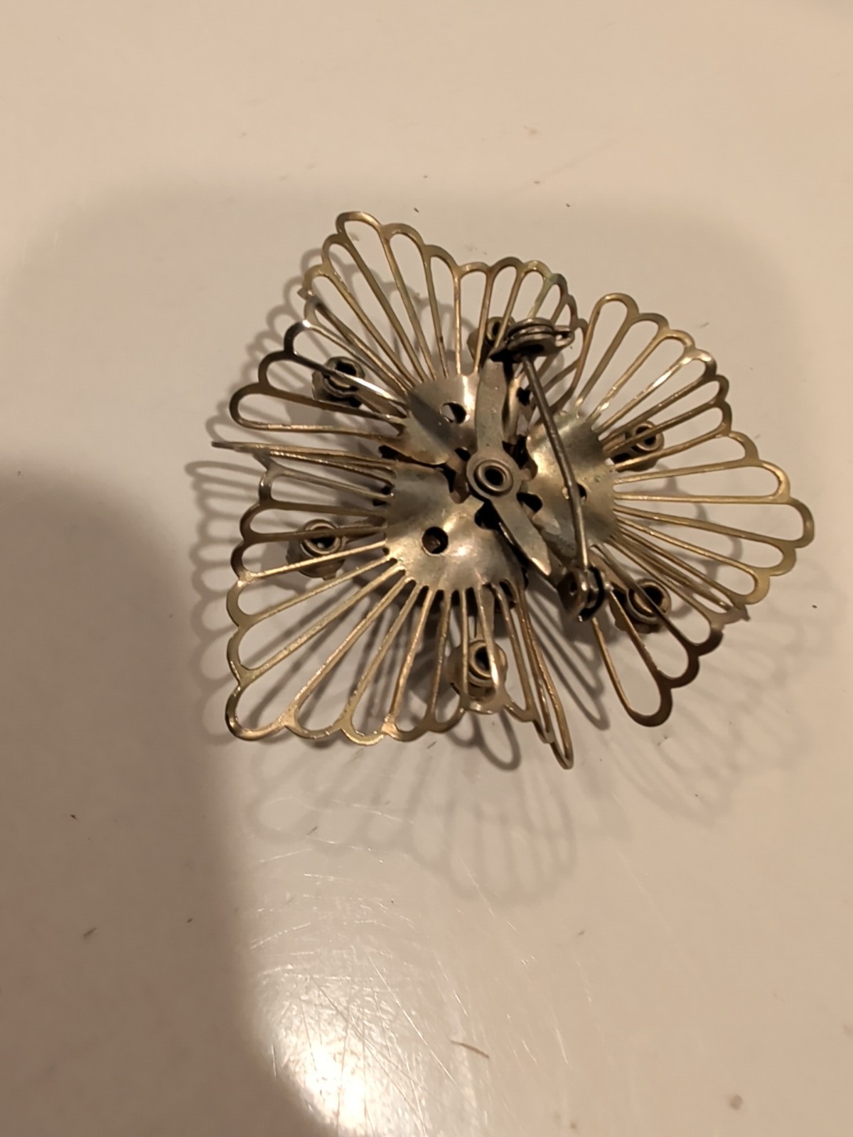 Vintage Coro or Kramer starburst brooch with aurora borealis rhinestones. USA.