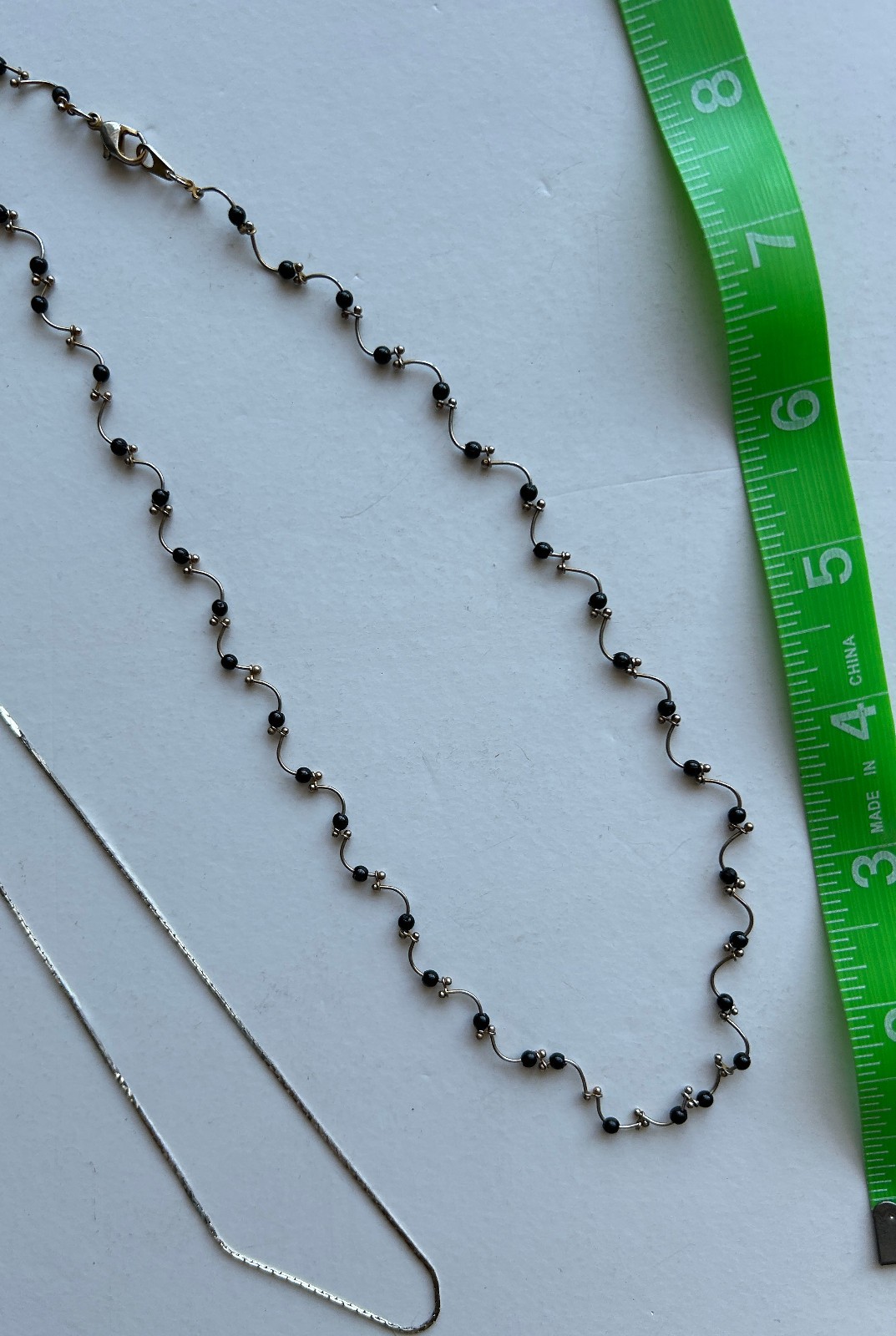 Lot of 2 Delicate Silvertone necklaces -One with black beads curvy design strand