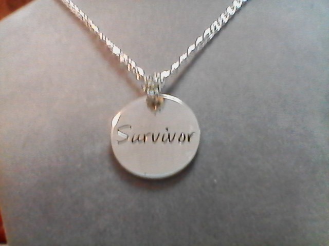 16″ vintage chain with a rhinestone bail holding a “survivor” charm