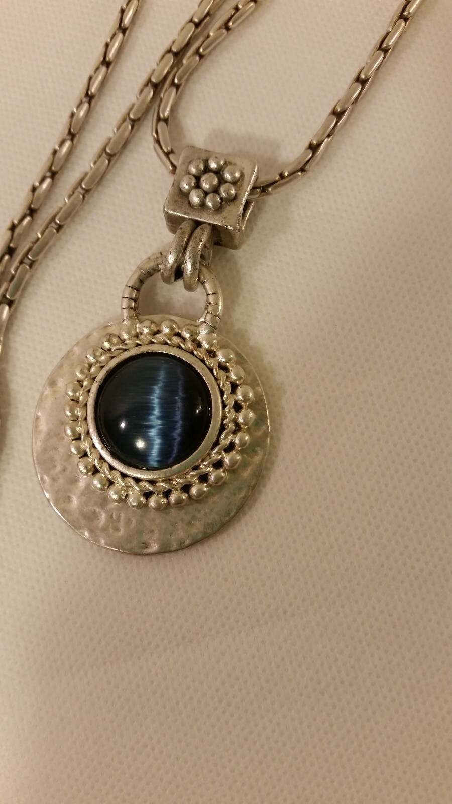 Blue Tiger Eye Cabochon style pendant with a convex formed silver toned reverse