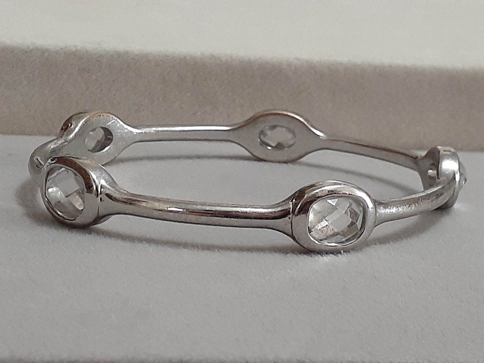 Fauceted crystal accent bangle bracelet Silvertone bezel set stones