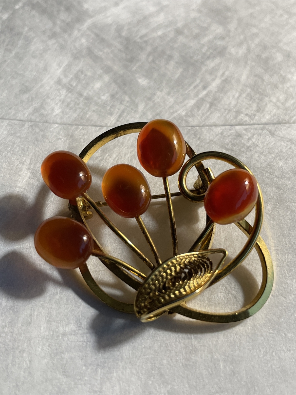 Vintage gold tone brooch with amber colored stones