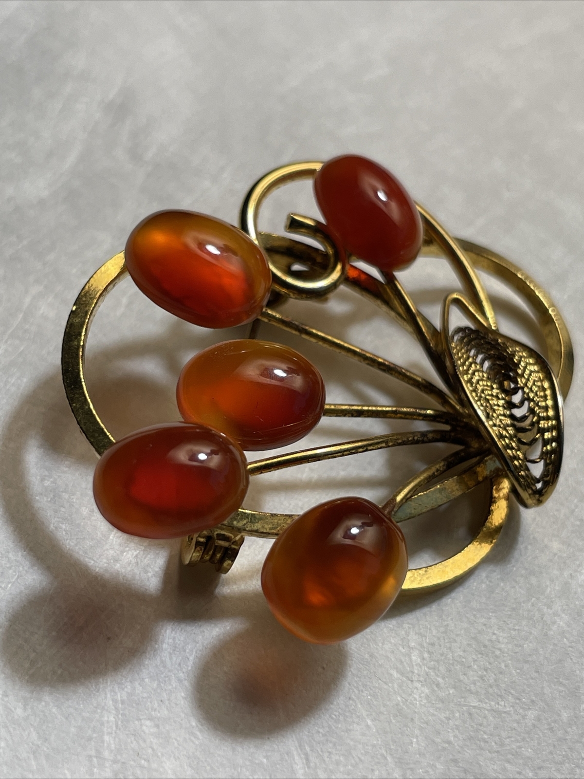 Vintage gold tone brooch with amber colored stones