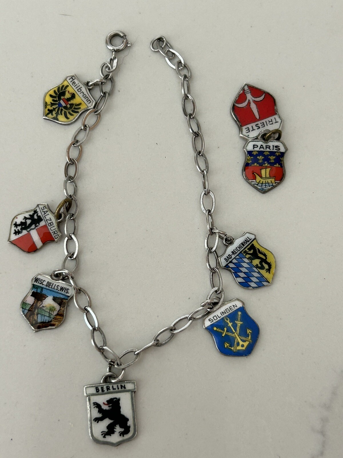VINTAGE SOLID SILVER AND ENAMEL TRAVEL CHARM BRACELET6 COAT OF ARMS (8 TOTAL)